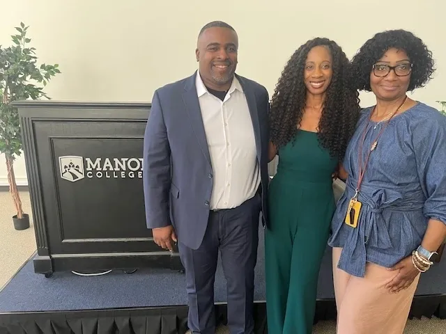 Three people posing at Manor College.